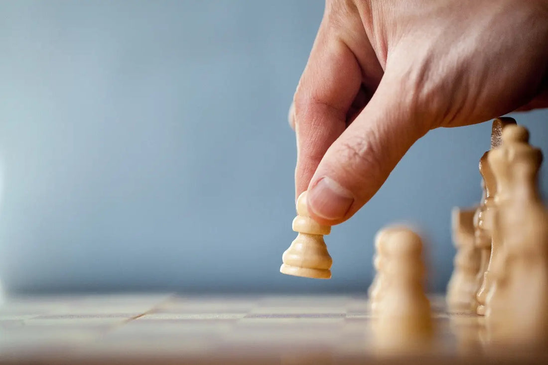 Hand moving a chess piece