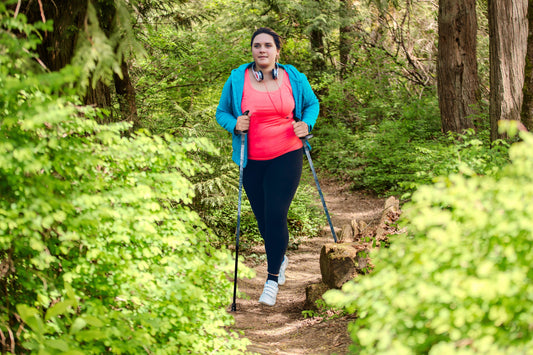 Woman with Walking Poles on a Trail in the woods